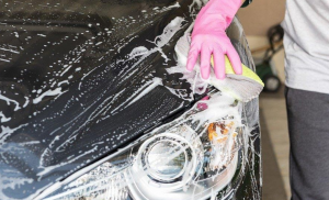 Hand washing your car with lots of soap